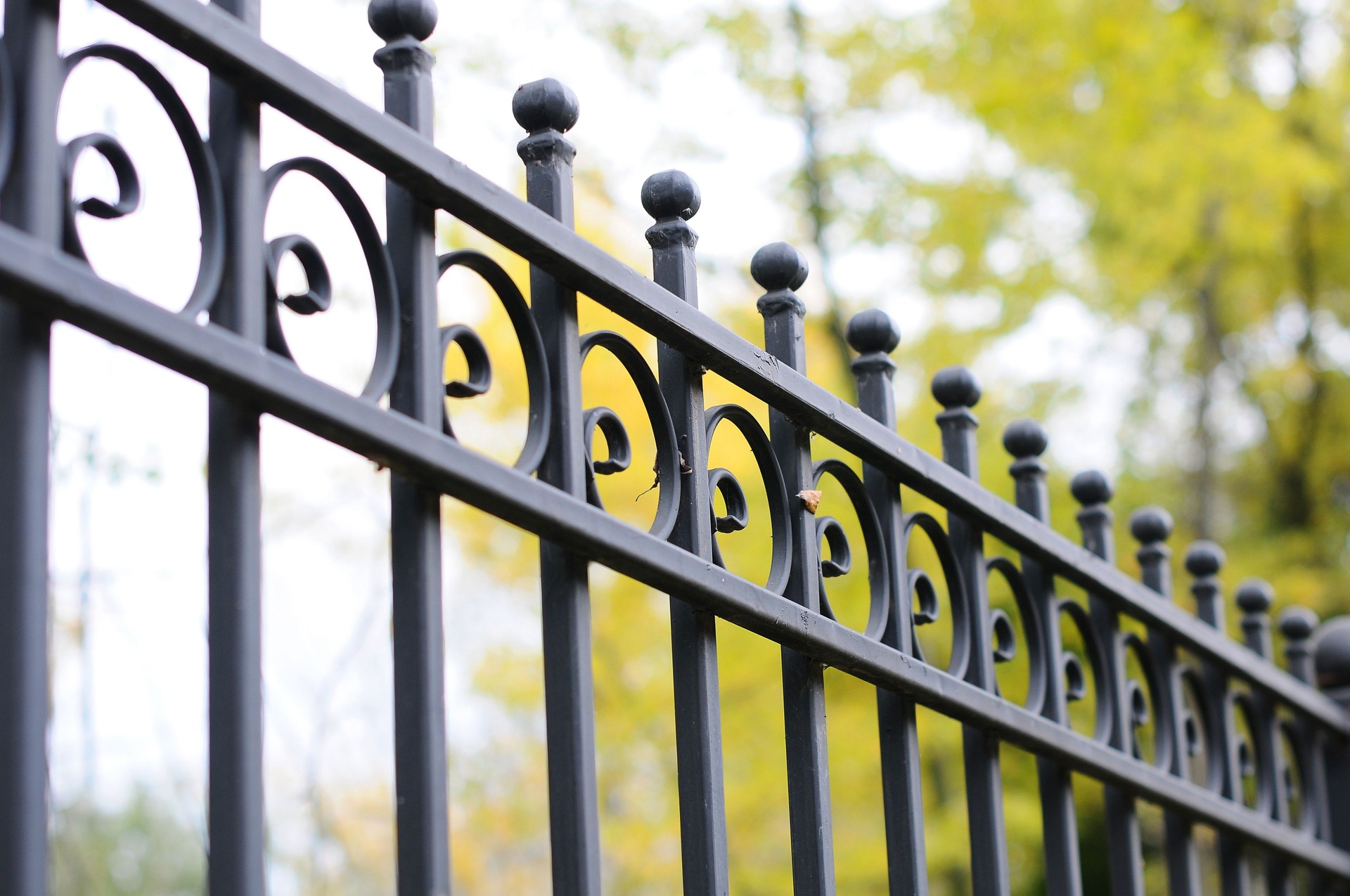 Beautiful decorative cast metal wrought fence with artistic forging. Iron guardrail close up.